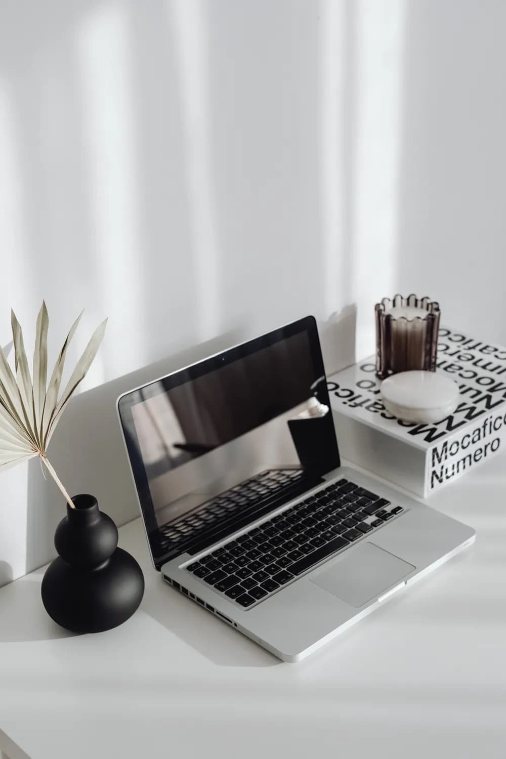 A laptop on a bright, minimal desk